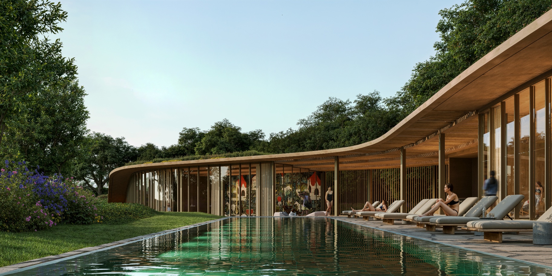 Long infinity pool with loungers at water level, beside the curved timber pavilion